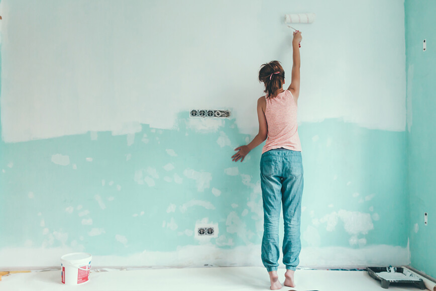 Women painting wall