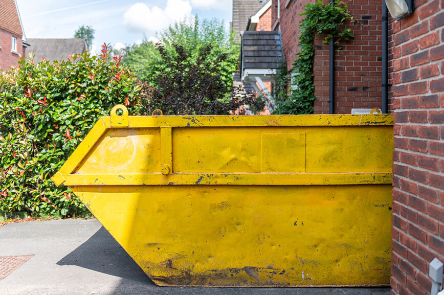 Large yellow skip bin outside property