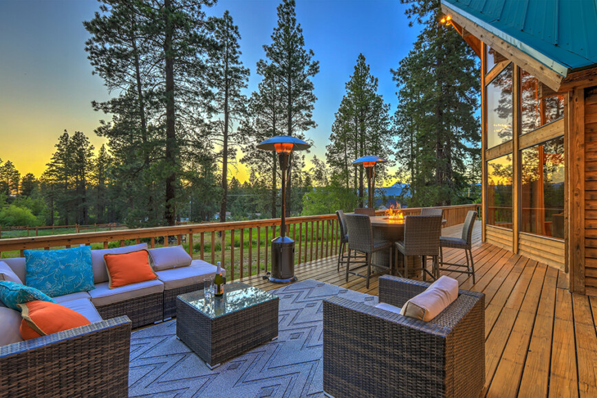 Log cabin with decking. Decking with outdoor furniture and  heat lamps