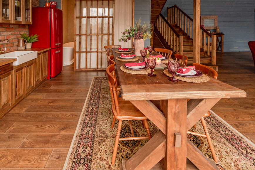 Cosy wood log cabin with wooden dining table and kitchen